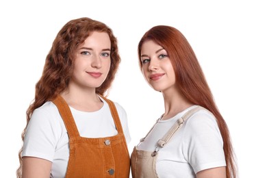 Photo of Portrait of beautiful young redhead sisters on white background