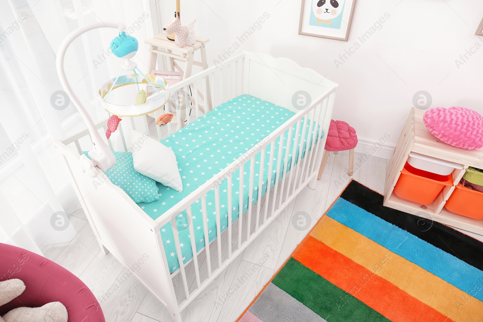 Photo of Colorful baby room interior with comfortable crib