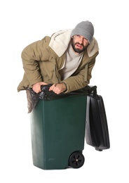 Photo of Poor homeless man in trash bin isolated on white