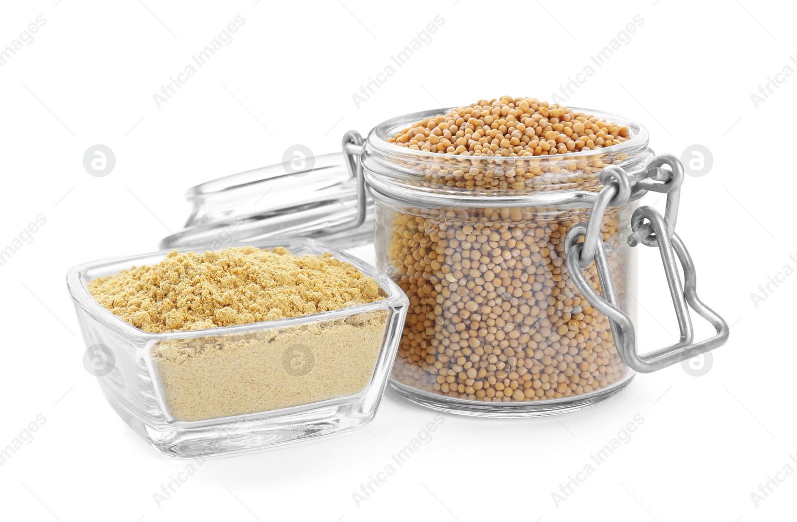 Photo of Aromatic mustard powder in bowl and glass jar with seeds on white background