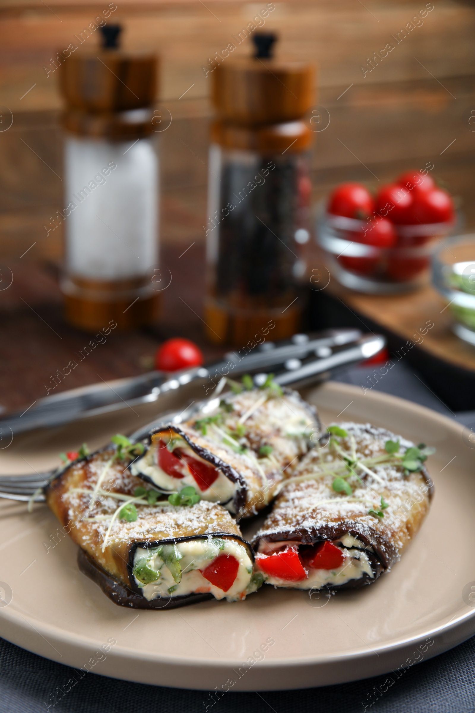 Photo of Delicious baked eggplant rolls served on table, closeup