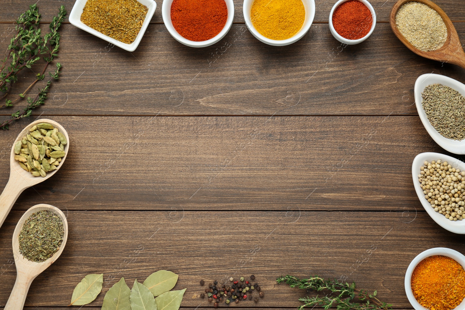 Photo of Many different spices on wooden table, flat lay. Space for text