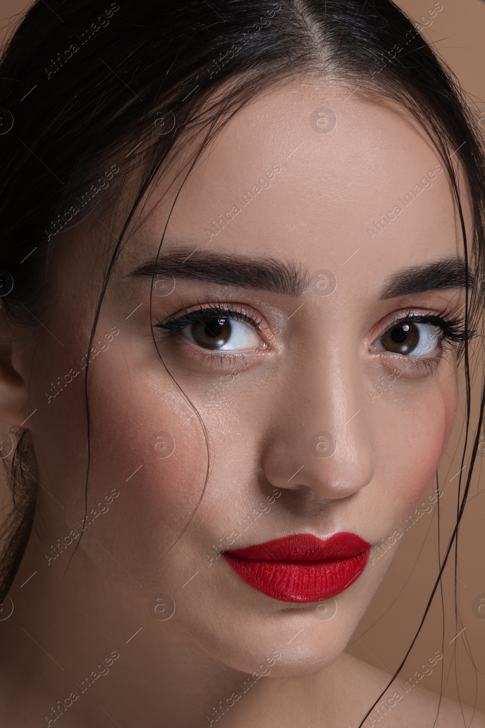 Photo of Portrait of beautiful young woman with red lips, closeup