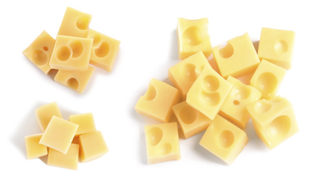 Set of delicious cheese cubes on white background, top view