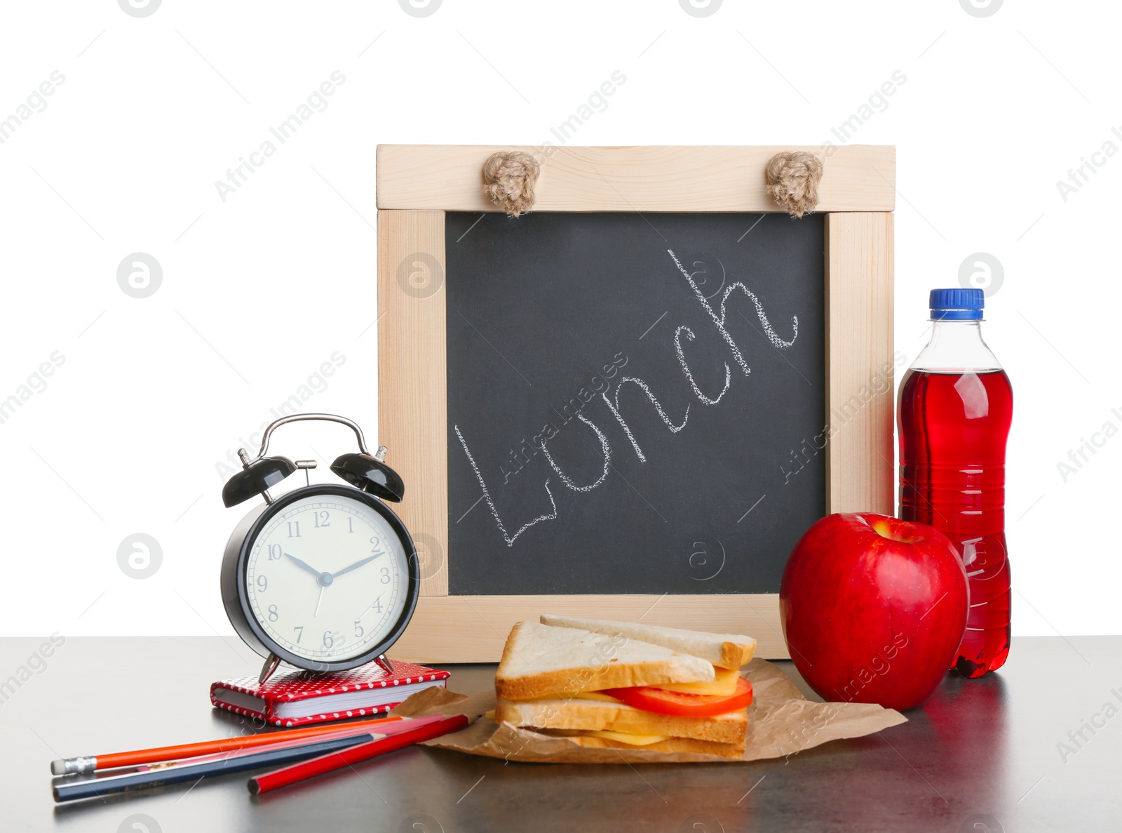 Photo of Tasty sandwich, apple and bottle of drink for school lunch on table