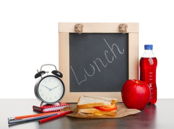 Tasty sandwich, apple and bottle of drink for school lunch on table