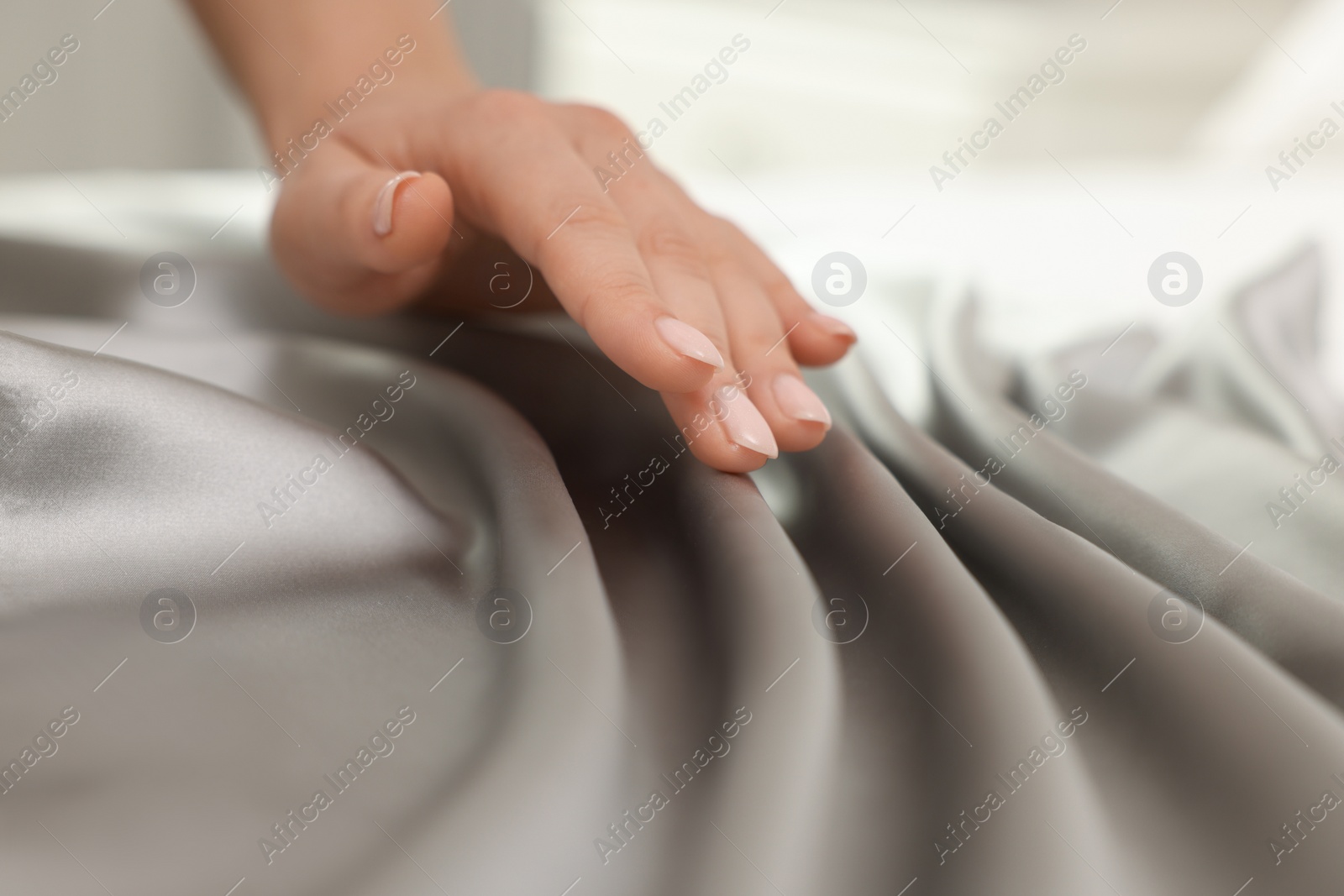 Photo of Woman touching smooth silky fabric, closeup view