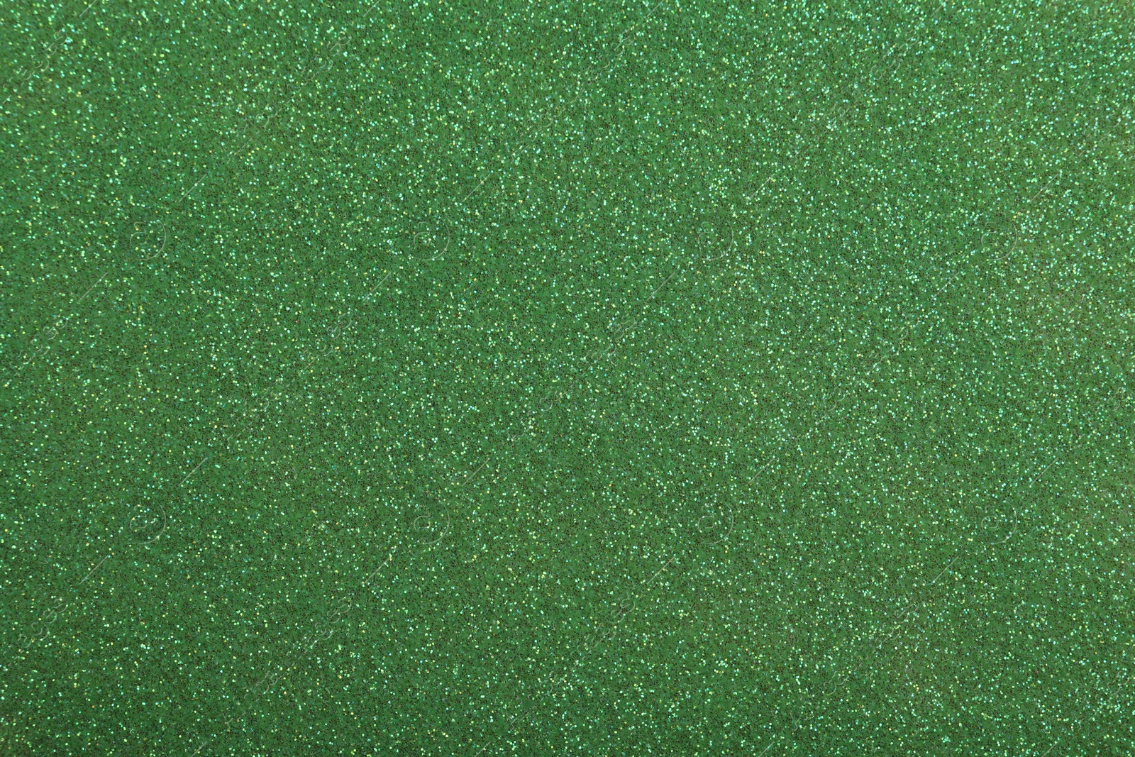 Photo of Beautiful shiny green glitter as background, closeup