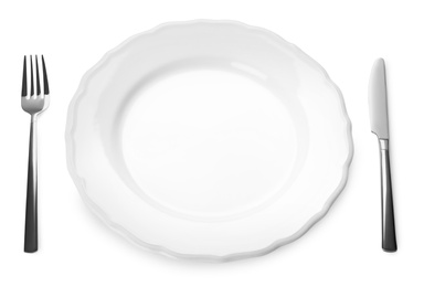 Photo of Empty plate and cutlery on white background. Table setting
