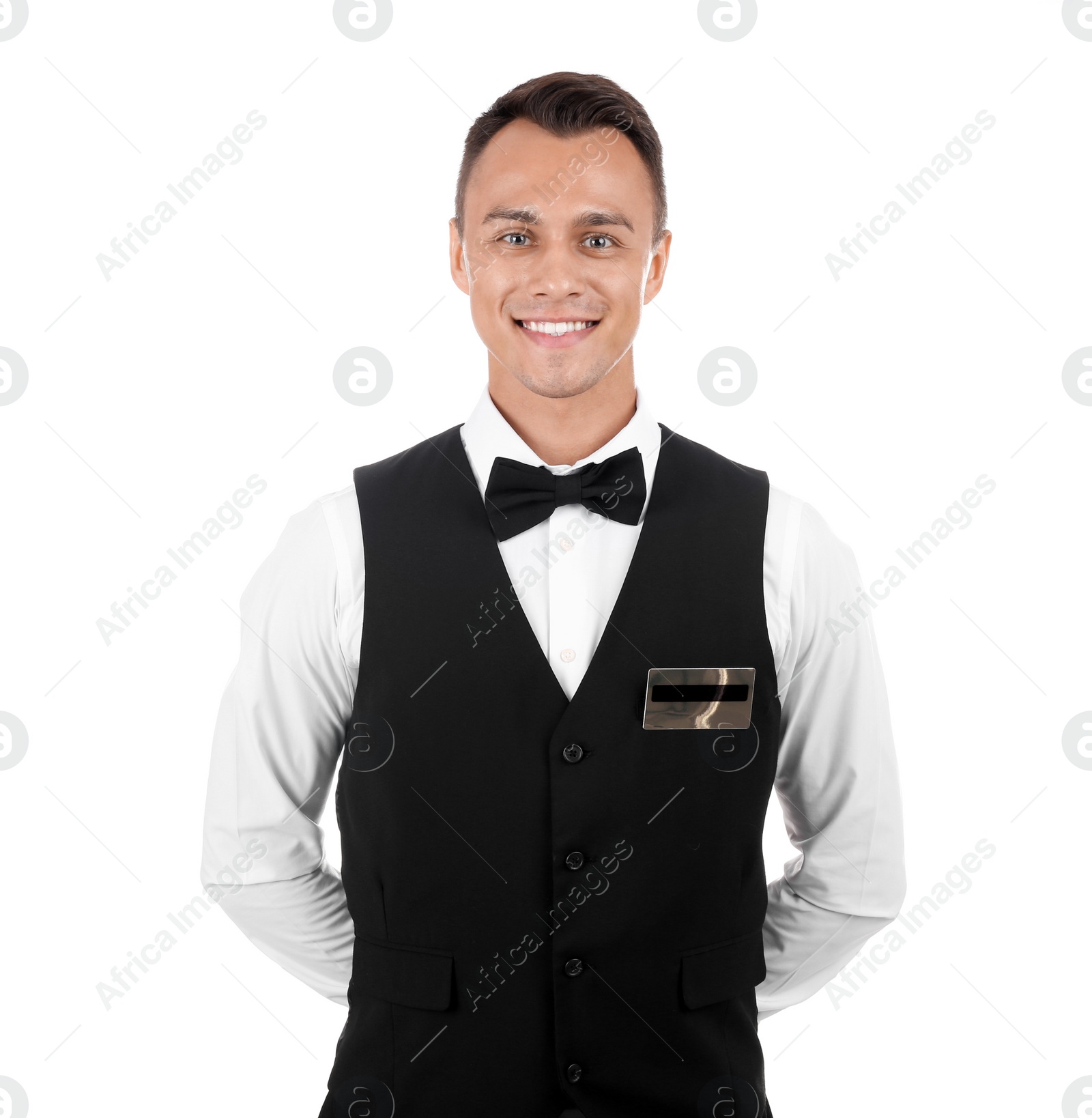 Photo of Portrait of young waiter in uniform on white background