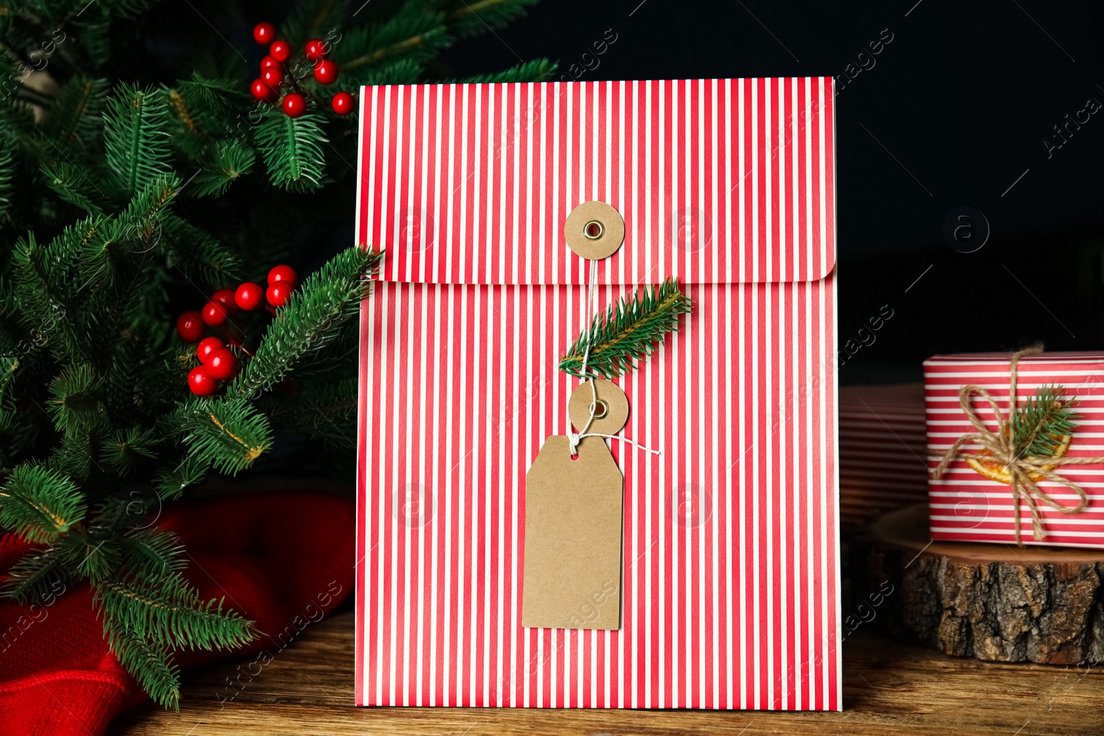 Photo of Beautifully decorated Christmas present on wooden table