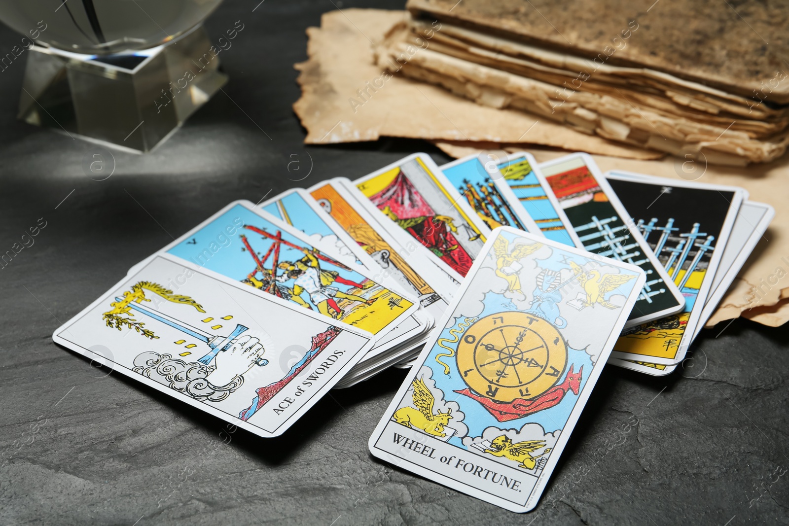 Photo of Wheel of Fortune and other tarot cards on black table