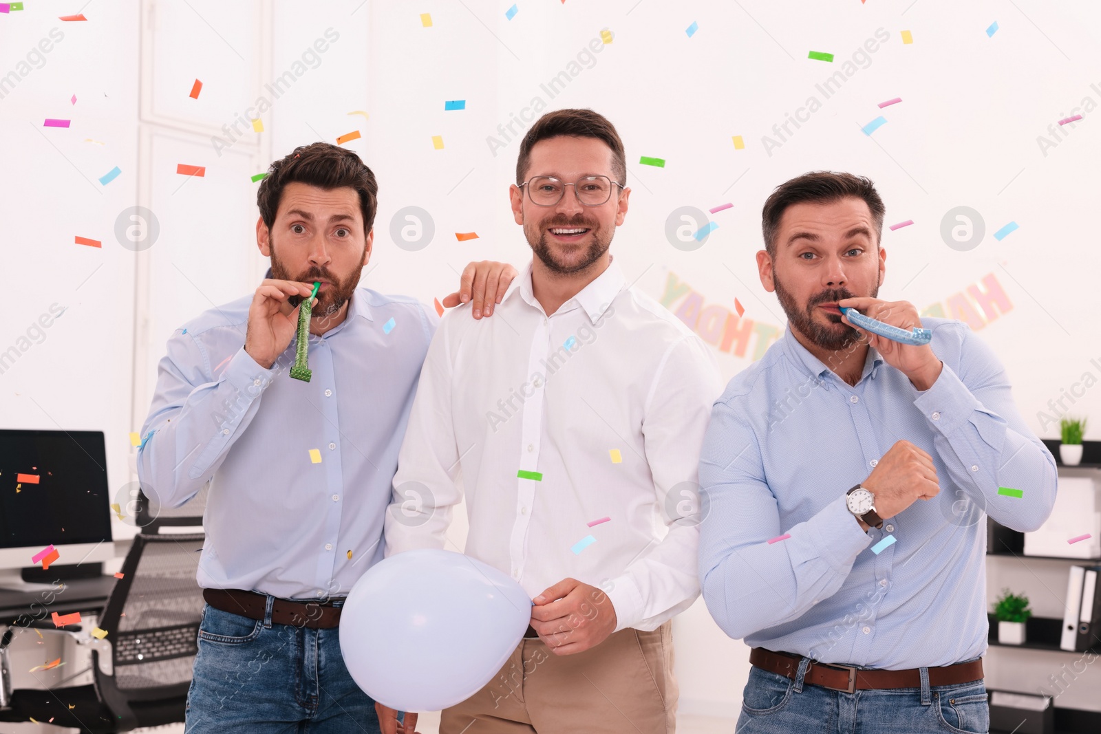 Photo of Coworkers having fun during office party indoors