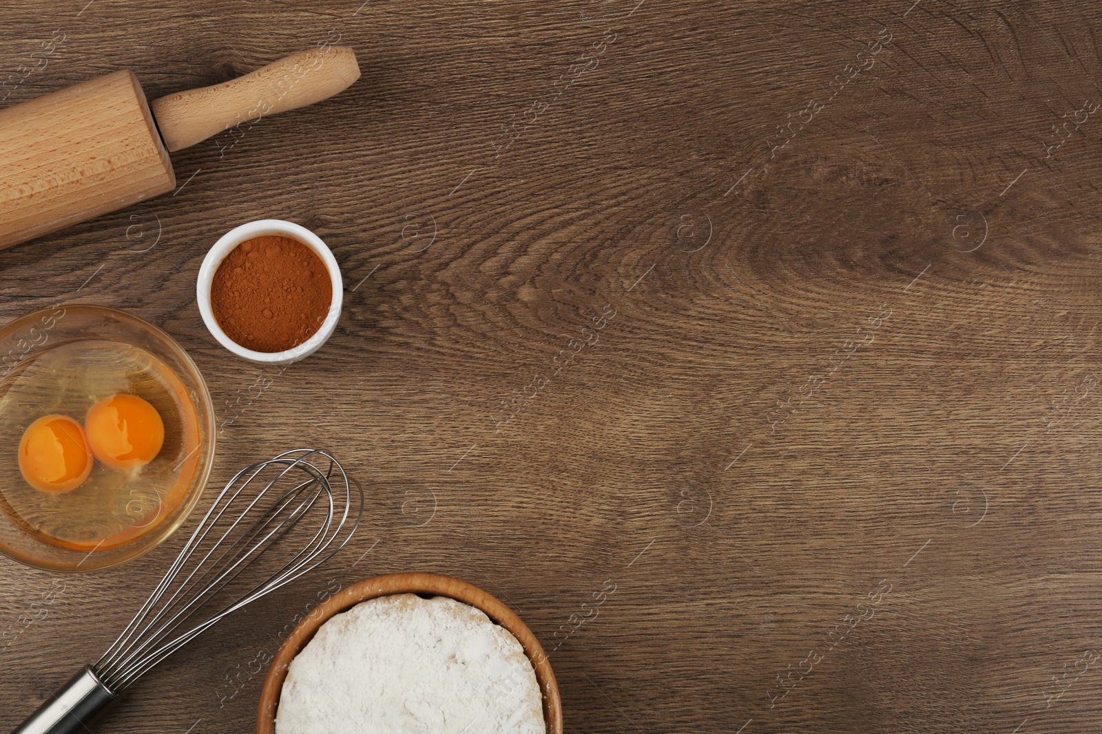 Photo of Flat lay composition with raw eggs and other ingredients on wooden table, space for text. Baking pie