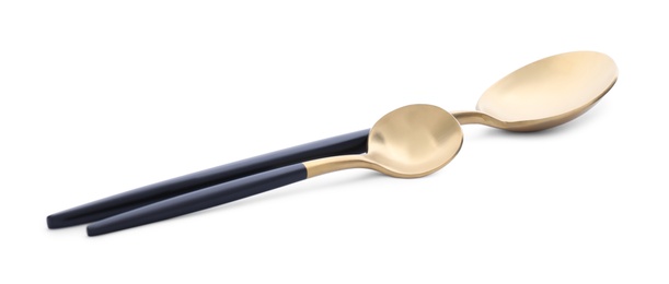 Elegant shiny golden spoons on white background