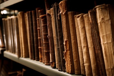 Image of Old books on shelf in library, closeup