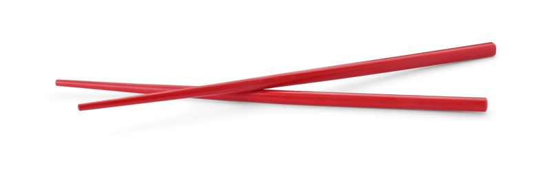 Photo of Pair of red chopsticks isolated on white