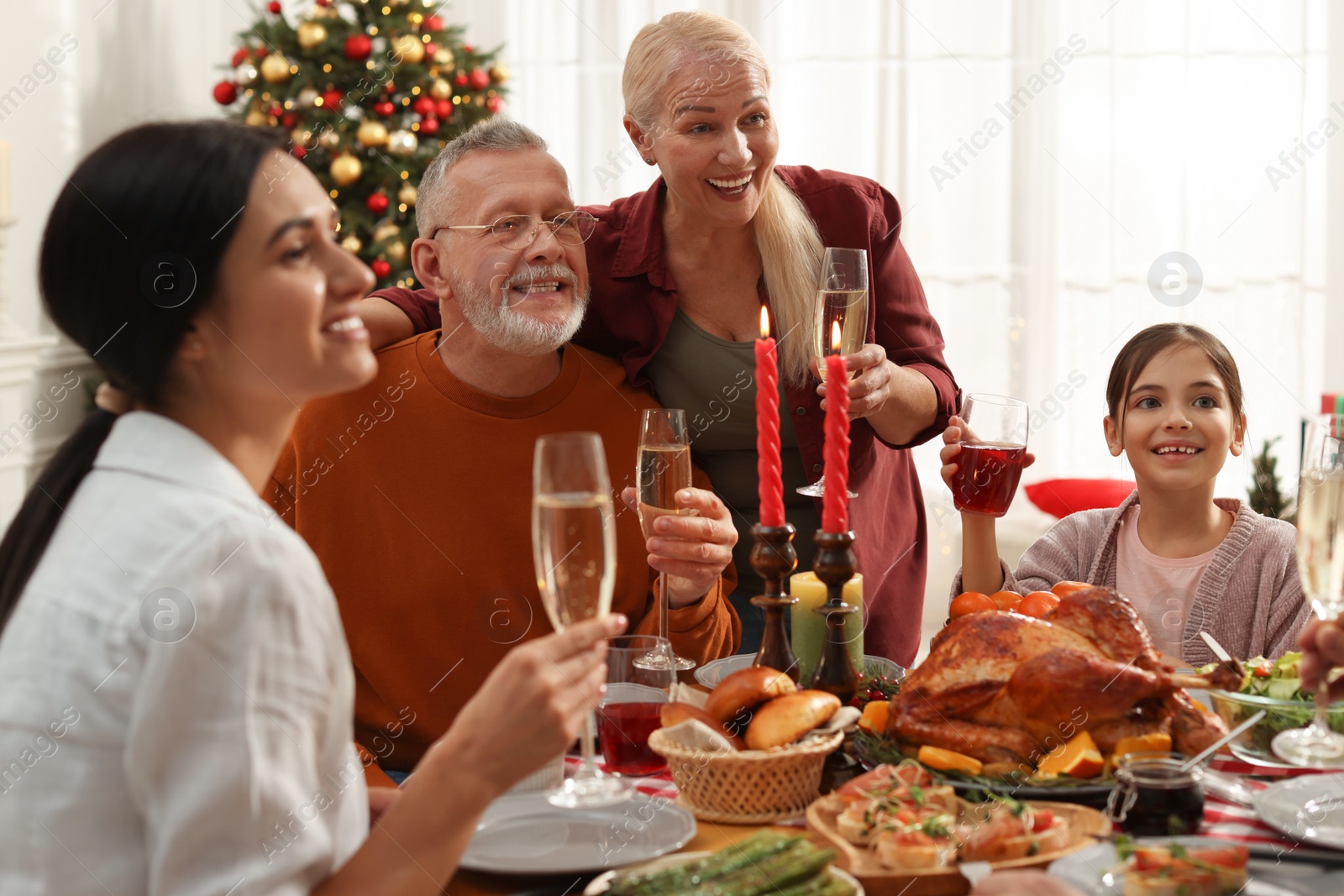 Photo of Happy family enjoying festive dinner at home. Christmas celebration