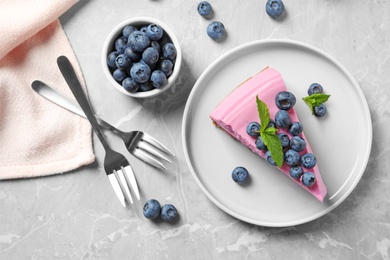 Photo of Flat lay composition of tasty blueberry cake on grey table