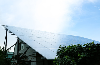 House with installed solar panels on roof. Alternative energy source