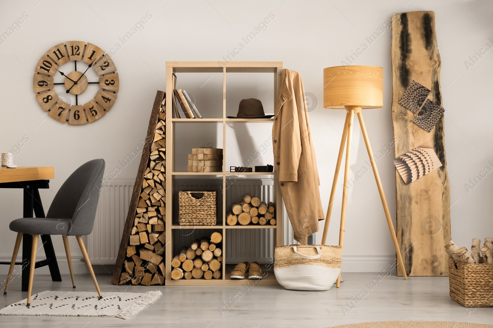 Photo of Stylish room interior with firewood as decorative element