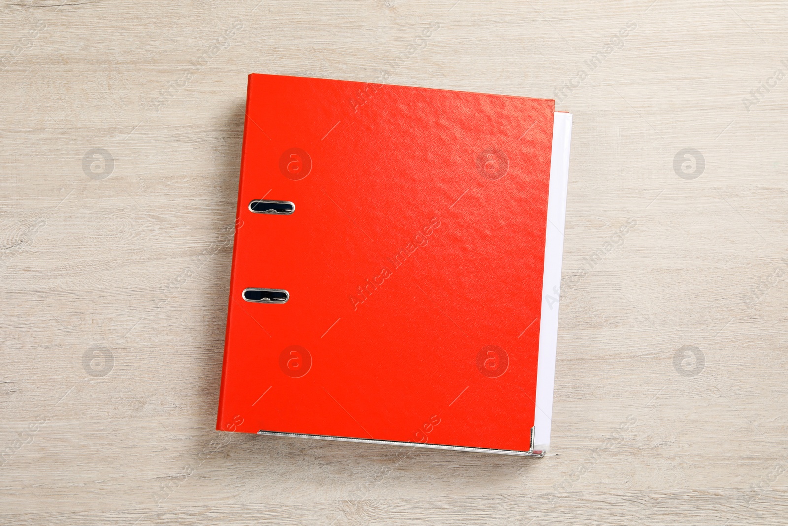 Photo of Orange office folder on white wooden table, top view