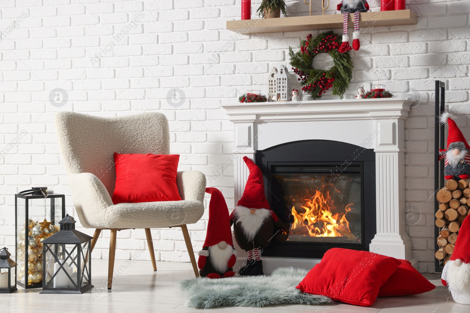 Photo of Beautiful Christmas themed photo zone with armchair and fireplace in room