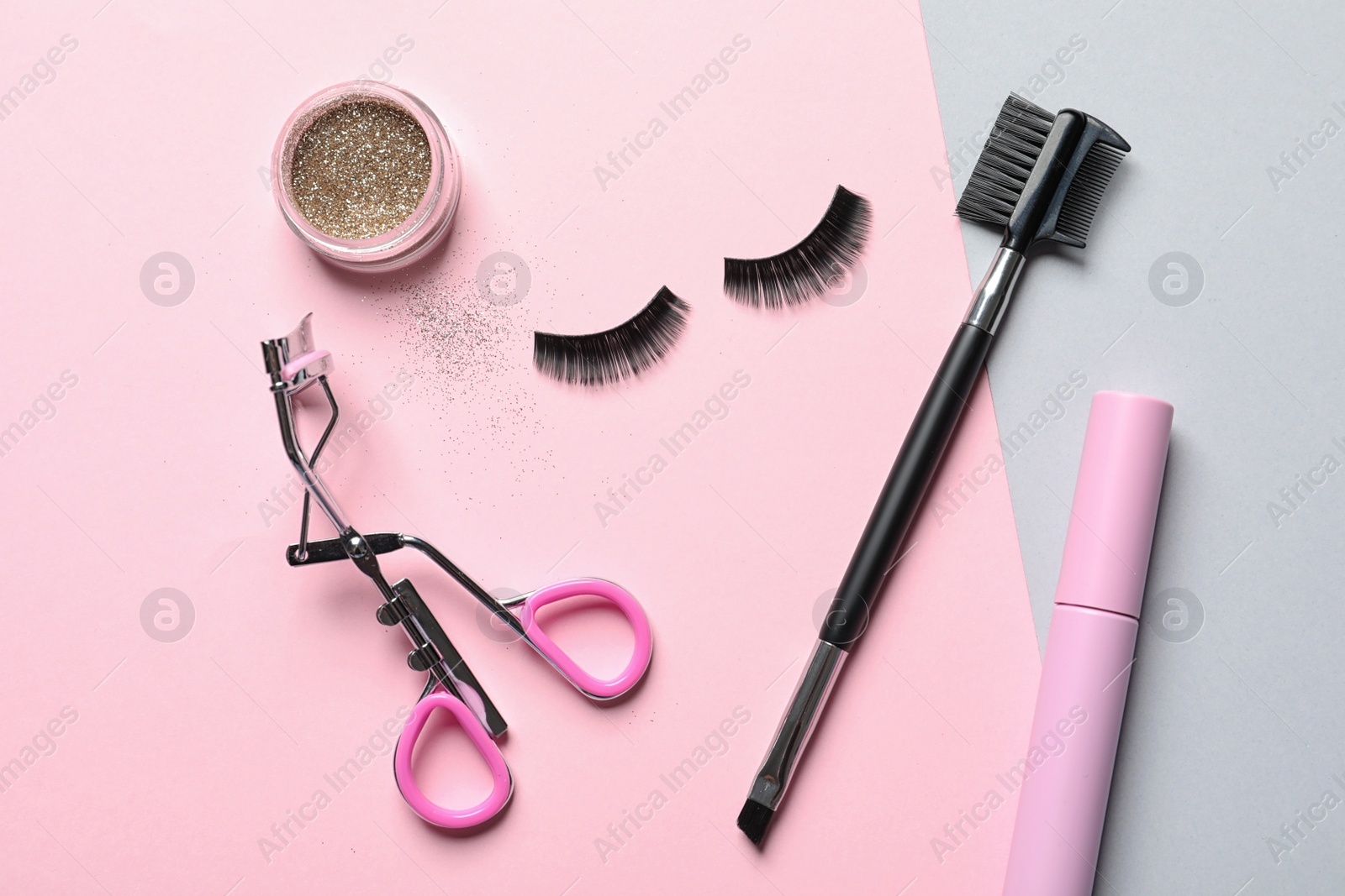 Photo of Flat lay composition with false eyelashes and other makeup products on color background