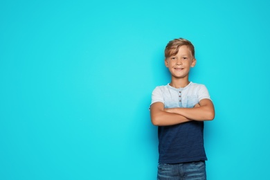 Photo of Little happy school child on color background