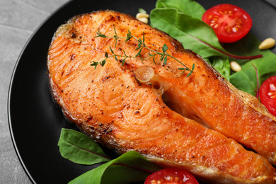 Delicious roasted fish served on plate, closeup