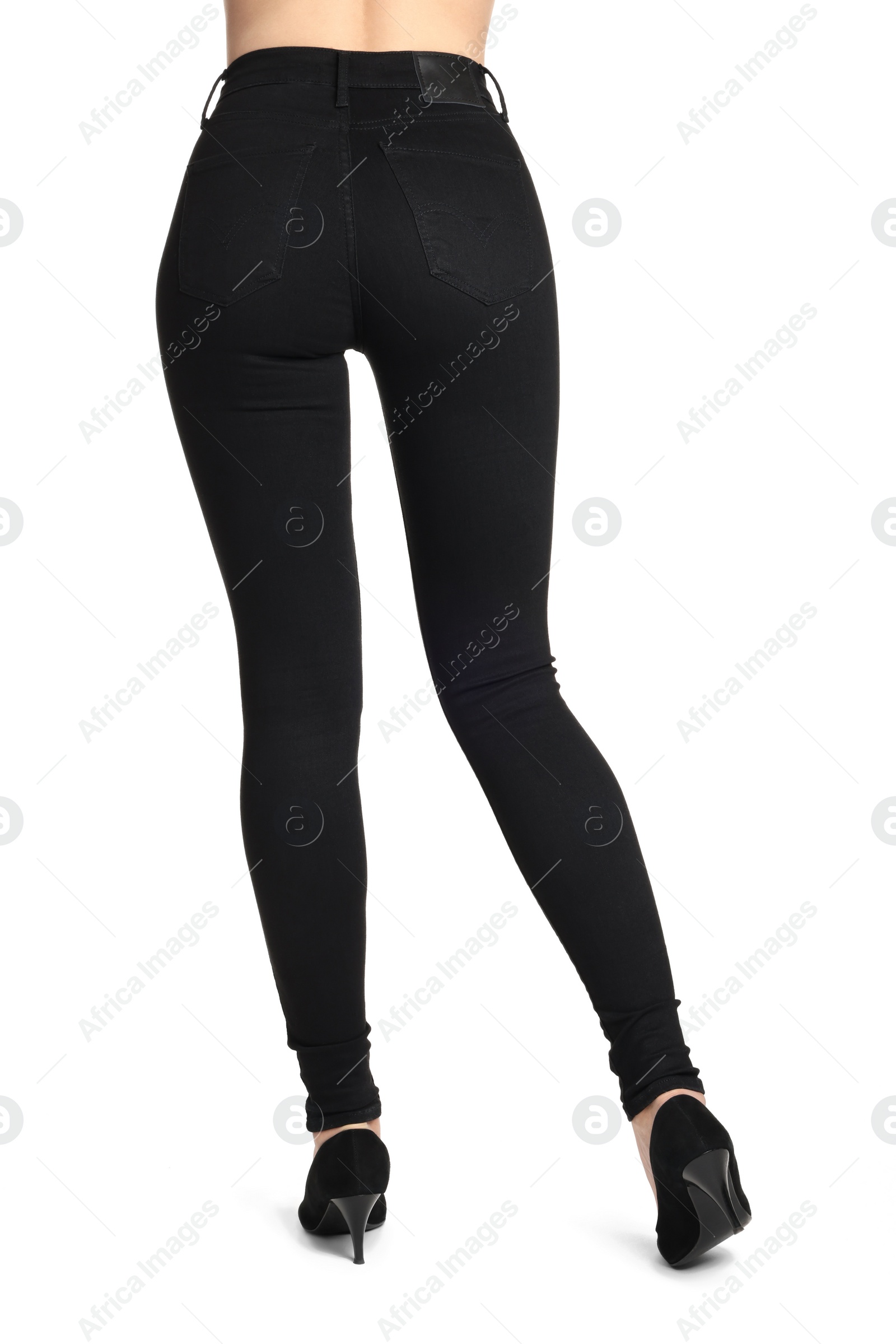 Photo of Woman wearing stylish black jeans and high heels shoes on white background, closeup