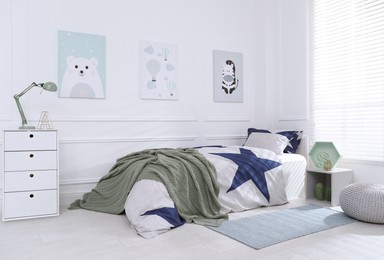 Photo of Bed with stylish linens in children's room