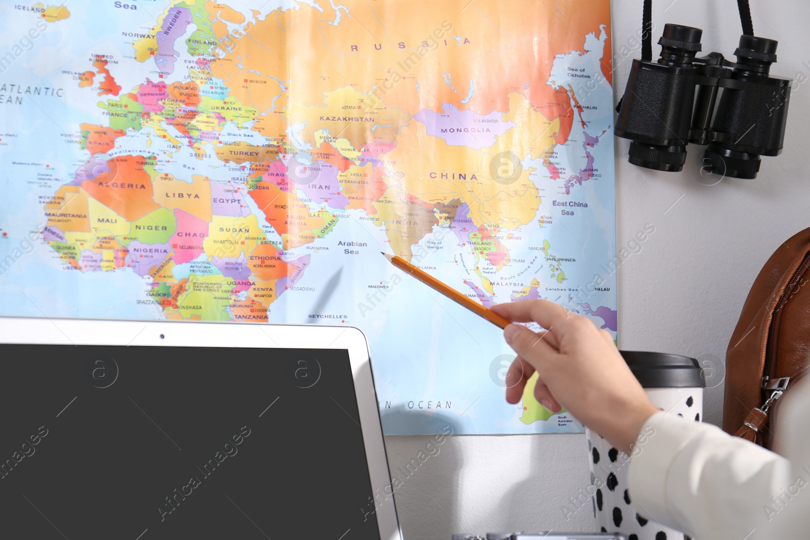 Photo of Woman with world map planning trip at home, closeup. Summer vacation