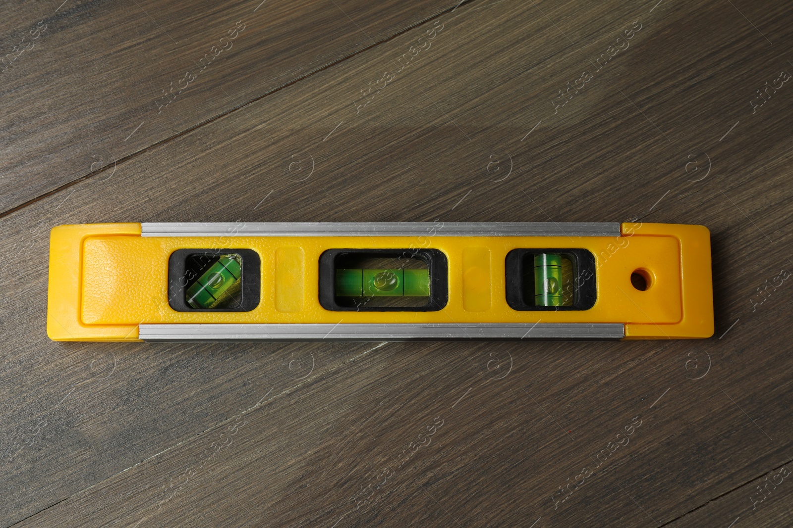 Photo of Building level on wooden table, top view