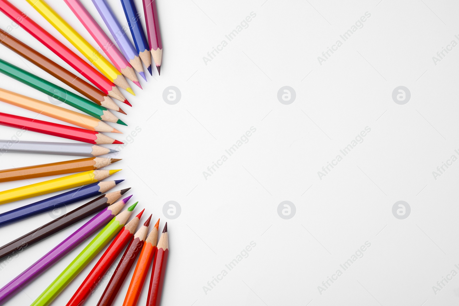 Photo of Colorful wooden pencils on white background, flat lay. Space for text