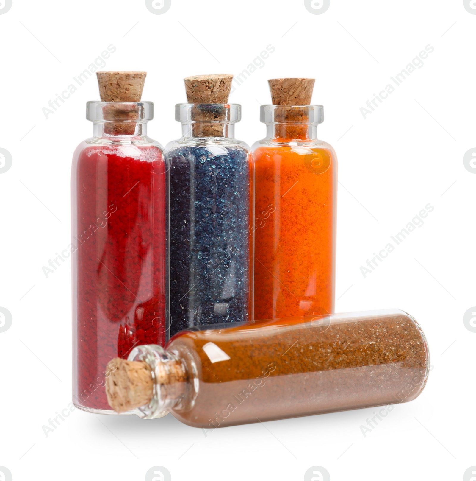 Photo of Glass bottles of different food coloring isolated on white