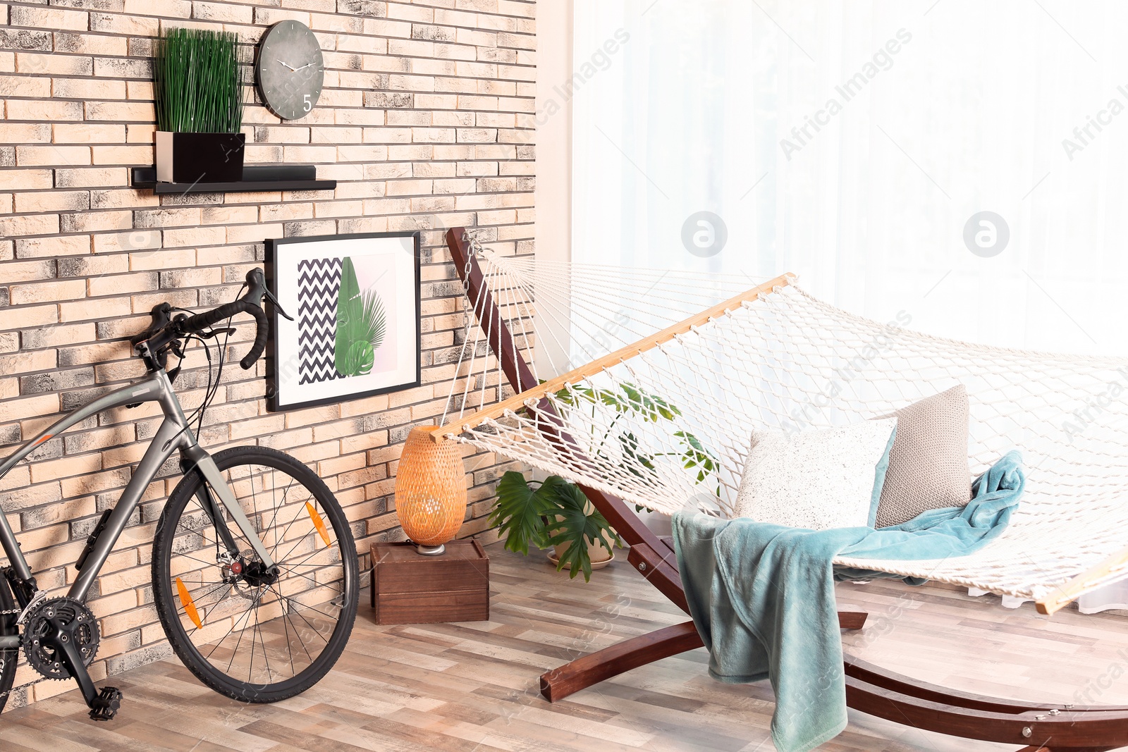 Photo of Modern bicycle and hammock in stylish room interior