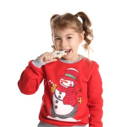 Cute little girl with Christmas gingerbread cookie on white background