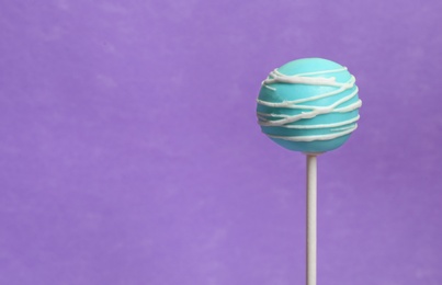 Photo of Bright delicious cake pop on color background. Space for text