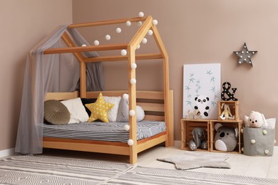 Photo of Stylish child room interior with comfortable floor bed