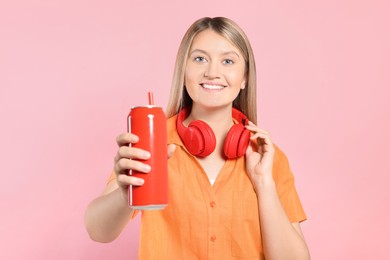 Photo of Beautiful happy woman holding red beverage can on pink background