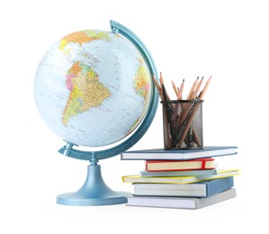 Plastic model globe of Earth, colorful pencils and books on white background. Geography lesson