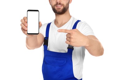 Professional repairman in uniform showing smartphone on white background, closeup