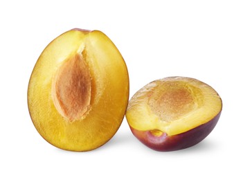 Halves of fresh ripe plum on white background