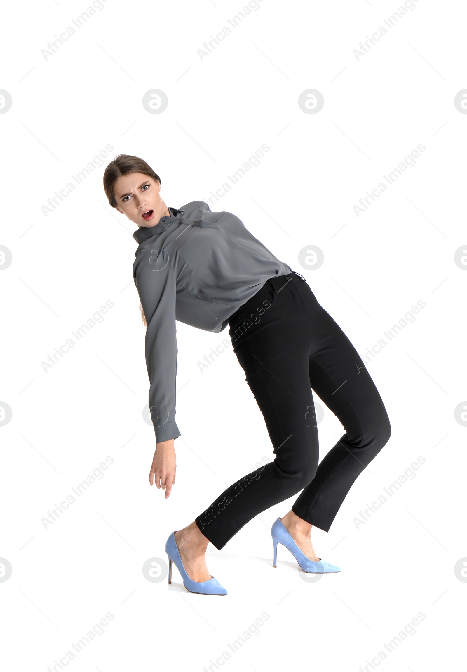 Photo of Young woman attracted to magnet on white background