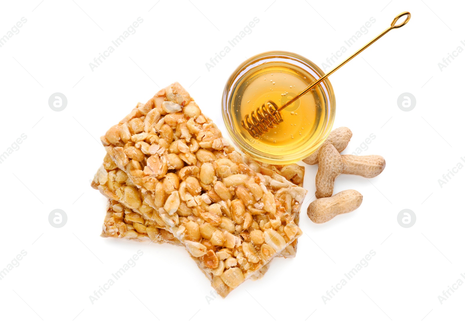 Photo of Tasty kozinaki bars, peanuts and honey isolated on white, top view