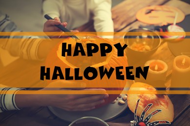 Image of Happy Halloween. Mother and daughter making pumpkin jack o'lantern at wooden table, closeup