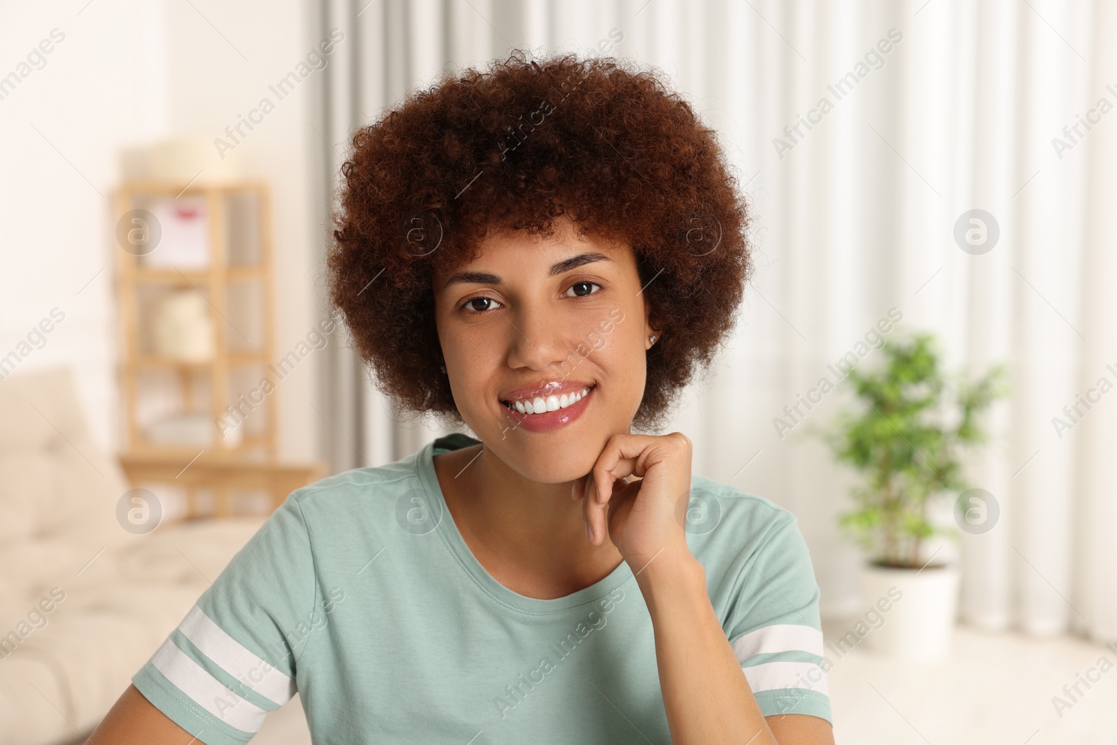 Photo of Portrait of happy young woman in room