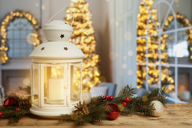Image of Composition with Christmas lantern on table in decorated room