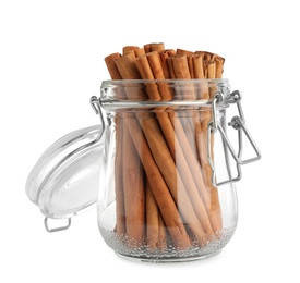 Photo of Aromatic dry cinnamon sticks in glass jar on white background